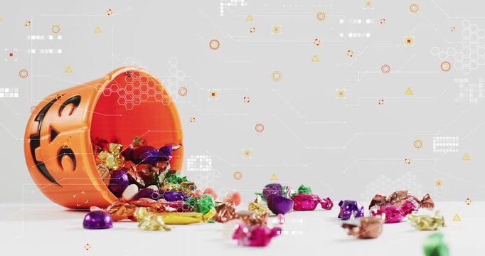 Orange pumpkin shape bucket entering above left, tilting, spilling candies, forming colorful trail