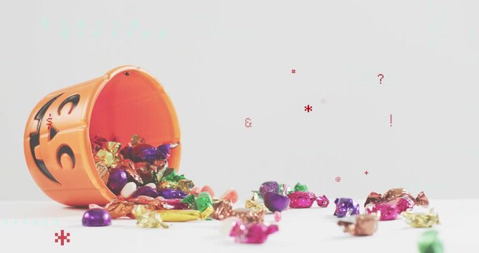 Jack-o'-lantern bucket dropping onto tabletop, spilling candies, transforming into pixel symbols
