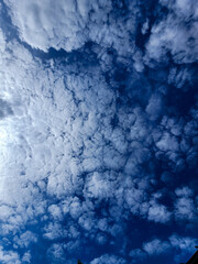 Photograph view of blue sky with beautiful white clouds and bright sun as a graphic resource