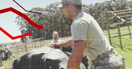 Mid adult man on start pushing tire across military field for training with animated distance - Powered by Adobe