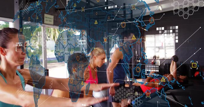 Group pulling rowing handles and squatting in gym for group workout, fading world-map overlay