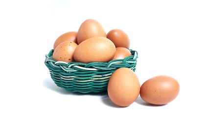 Front view Stack of fresh chicken egg in green basket wicker bamboo. Isolated on white background with copy space. Suitable for editing and used for food and nutrition advertising. Clipping path.