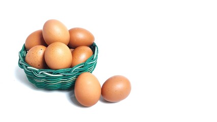 Side view Stack of fresh chicken egg in green basket wicker bamboo. Isolated on white background with copy space. Suitable for editing and used for food and nutrition advertising. Clipping path.
