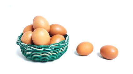 Stack of fresh chicken egg in green basket wicker bamboo. Isolated on white background with copy space. Suitable for editing and used for food and nutrition advertising. Clipping path.