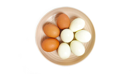 Top view of Peeled and unpeeled boiled chicken egg in white plate. Isolated on white background with copy space. Suitable for editing and used for food and nutrition advertising.