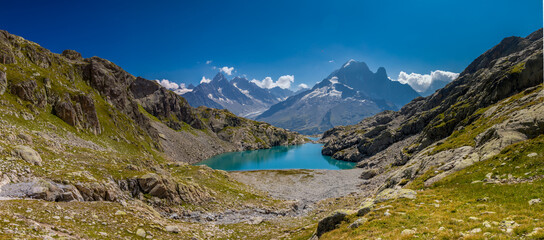 Mountain landscape of the Alps in Chamonix valley, France high resolution wide angle panoramic landscape. Alpine scenery in summer sunny weather on Tour du Mont Blanc, TMB trekking route