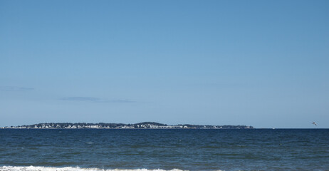 A breathtaking city view through the river, where the skyline reflects on calm waters and the urban lights blend with nature’s serenity. This scene captures the harmony between city life and natural