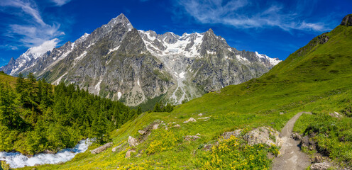 Mountain landscape of the Alps in Chamonix valley, France high resolution wide angle panoramic landscape. Alpine scenery in summer sunny weather on Tour du Mont Blanc, TMB trekking route