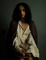 Sexy woman sitting on a chair wearing a men's shirt