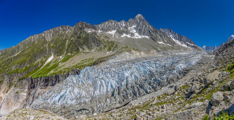 Mountain landscape of the Alps in Chamonix valley, France high resolution wide angle panoramic landscape. Alpine scenery in summer sunny weather on Tour du Mont Blanc, TMB trekking route