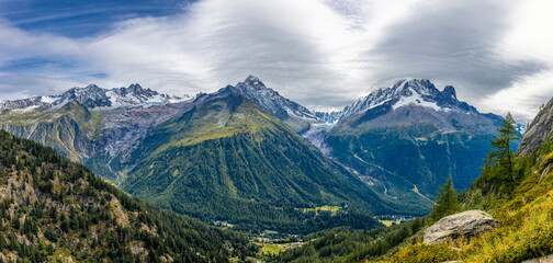Mountain landscape of the Alps in Chamonix valley, France high resolution wide angle panoramic landscape. Alpine scenery in summer sunny weather on Tour du Mont Blanc, TMB trekking route