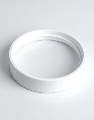 White cylindrical ring, possibly ceramic or plastic, with a slightly raised outer edge and subtle inner groove