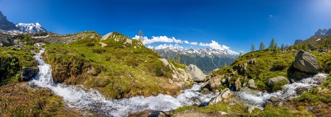 Mountain landscape of the Alps in Chamonix valley, France high resolution wide angle panoramic landscape. Alpine scenery in summer sunny weather on Tour du Mont Blanc, TMB trekking route
