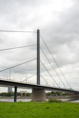 Cable-Stayed Bridge Spanning River Under Cloudy Sky