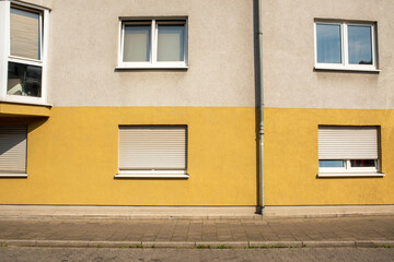 Modern Residential Building Facade with Yellow and Gray Wall