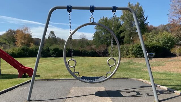 Vacant Circular Swing Suspended in Recreation Area Throughout Sunlit Day