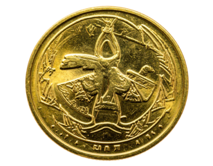 Detailed close-up of a golden coin, showcasing intricate relief engravings of a figure and symbolic elements.