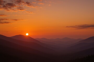 Majestic sunset over layered mountains with glowing clouds and golden alpine haze