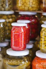 Colorful jars of preserved vegetables on display