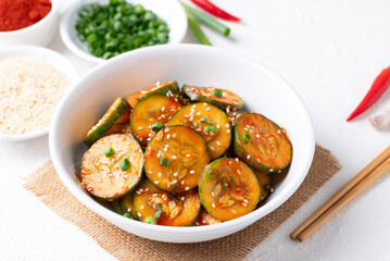 Korean cucumber salad (Oi muchim) in bowl on white background, Korean side dish