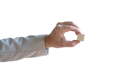 Businessman holding a piece of blank square wood block. Isolated on transparent background.