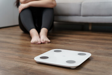 Sad woman with fat upset bored of dieting Weight loss fail  Fat diet and scale sad asian woman on...
