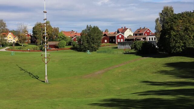 Leksand, Sweden A view of an open field in the town centre and a tall Maypole used during Midsummer celebrations. 