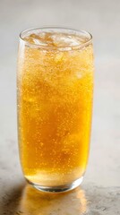 Sparkling peach tea in glass with effervescent fizz, clear tabletop and top margin open