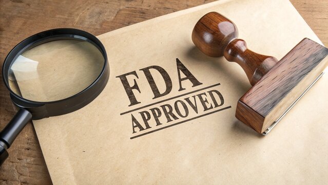 'FDA APPROVED' stamped on textured paper, beside a magnifying glass and wooden rubber stamp, symbolizing certification, quality assurance, and regulatory approval