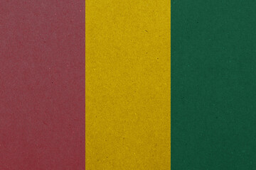 Abstract vertical tricolor background featuring textural burgundy, golden yellow, and dark green...