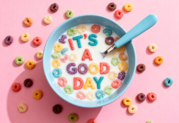 Bowl of cereal with "It's a good day" text sits on a pink surface.
