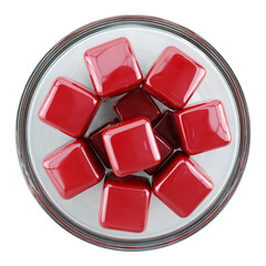 Overhead shot of a glass bowl filled with red square shaped candies isolated on transparent background