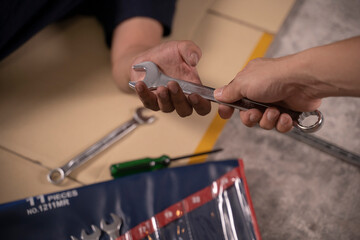 Two handsome mechanics are working together on a car repair.