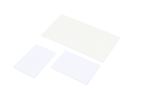 Three blank white cards of varying sizes, isolated on white, PNG