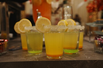 Colorful drinks with lemon slices and sugar rims.