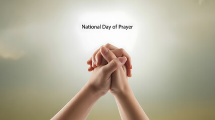 Hands clasped in prayer against a soft, glowing background with the text 'National Day of Prayer'