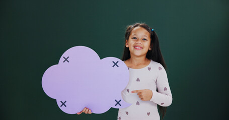 Portrait, pointing and girl in studio, speech bubble and announcement on green background. Kid, happiness and cloud space with card, promotion and smile with feedback, mockup and offer information