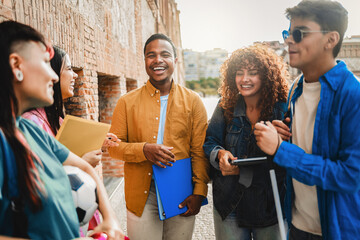 Young diverse students smiling outdoors at university campus. Friendship education and inclusion concept
