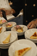 Plates of bread slices are being prepared for serving.
