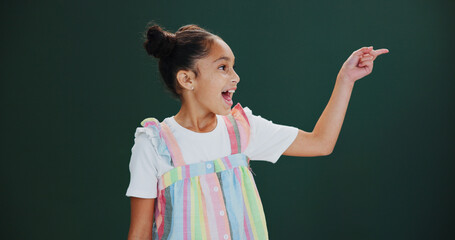 Studio, announcement and child with smile, pointing and happy for presentation, news or mockup...