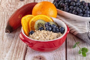 Oats porridge with blueberry, kiwi and orange