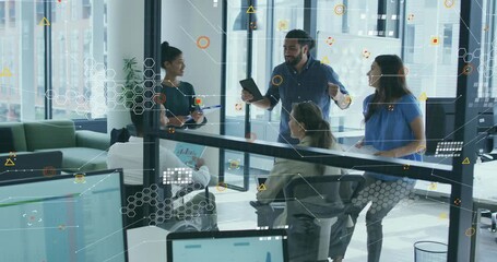 Presenter tapping tablet and gesturing on business whiteboard demo while colleagues jotting notes - Powered by Adobe