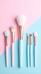 Makeup brushes in pastel colors on a dual-toned background