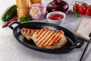 Tasty hot grilled bone steak served sauce