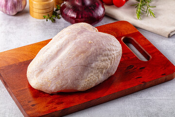 Raw chicken breast with bone and skin