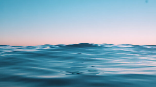 Calm ocean waves under a clear sky at twilight