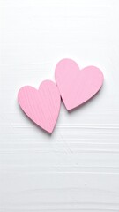 Two pink hearts on a white surface
