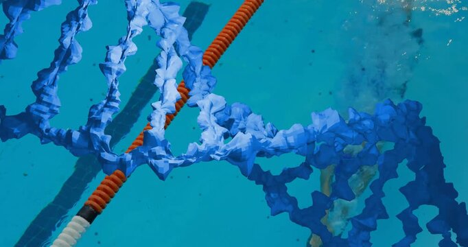 Woman swimmer passing rope, swimming, creating currents twisting blue ribbons for sports training