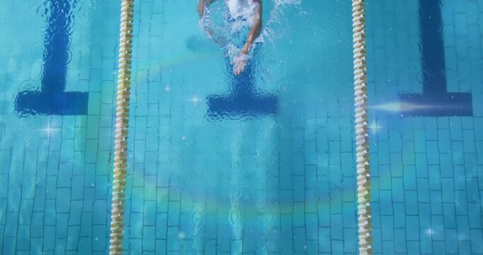 Male swimmer initiating lap turn by generating wall bubbles, pushing off performing front crawl