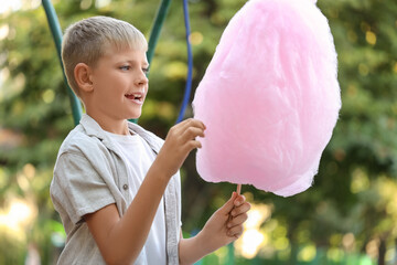 Teen boy with cotton candy in amusement park